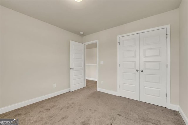 unfurnished bedroom with a closet and carpet floors