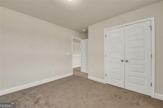 unfurnished bedroom with carpet and a closet