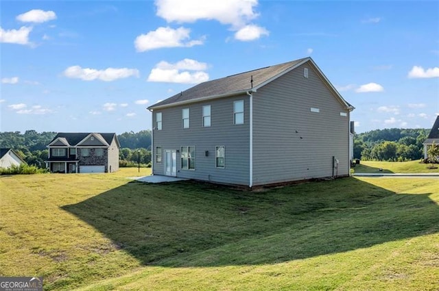 rear view of house with a yard