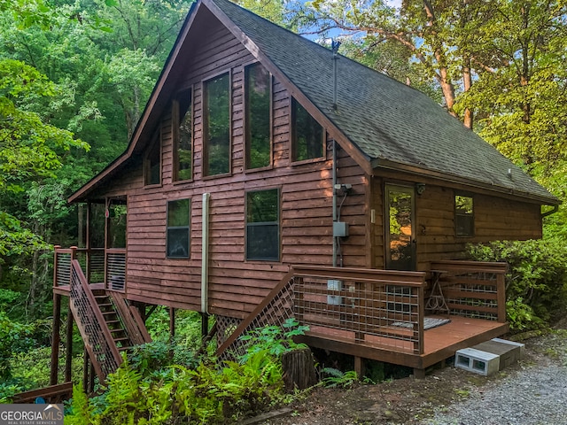 view of side of home featuring a wooden deck