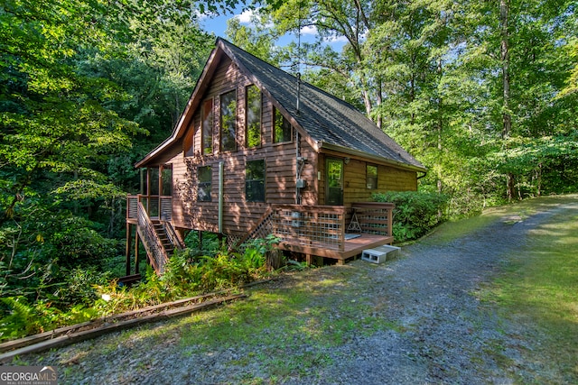 view of property exterior with a deck