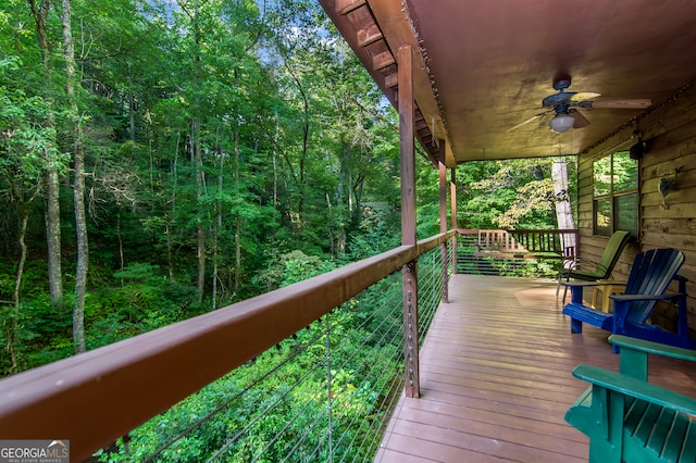 wooden deck featuring ceiling fan