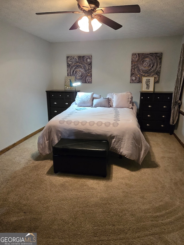 bedroom with carpet, ceiling fan, and a textured ceiling