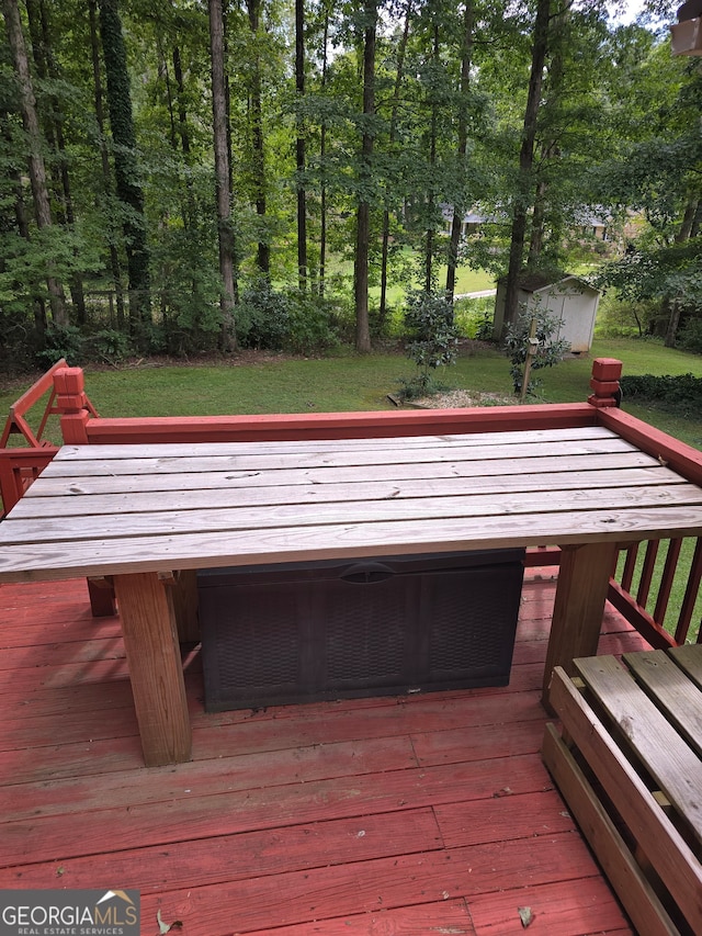 wooden deck featuring a yard