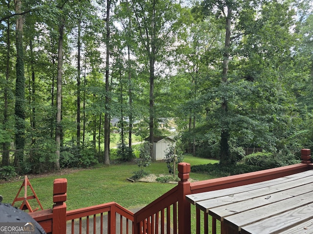 deck featuring a lawn and a storage unit