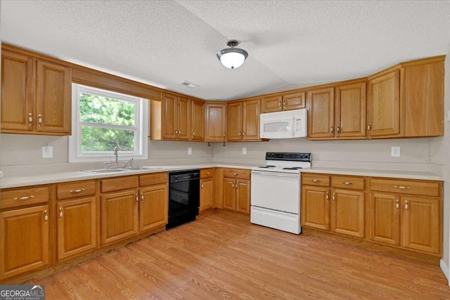 kitchen with white appliances, light hardwood / wood-style flooring, sink, and a textured ceiling