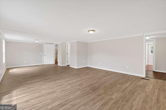 unfurnished living room with a textured ceiling and wood-type flooring