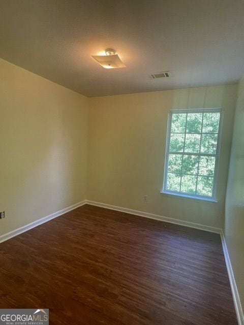 empty room with dark hardwood / wood-style floors