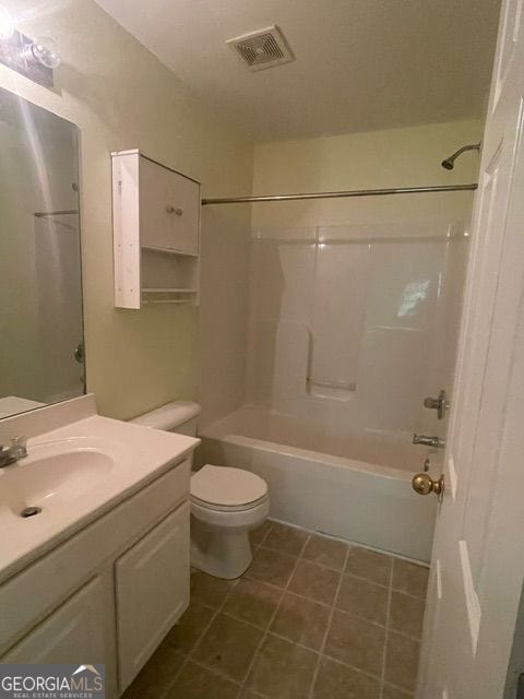 full bathroom with vanity, toilet, tile patterned floors, and shower / bathing tub combination