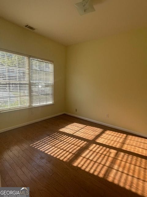 empty room with hardwood / wood-style flooring