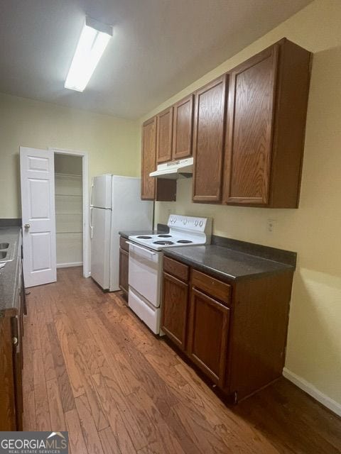 kitchen featuring wood-type flooring and white electric range oven