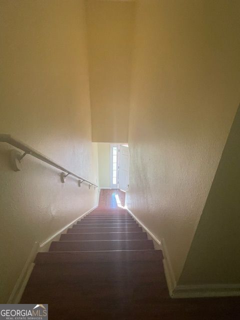 staircase with hardwood / wood-style floors