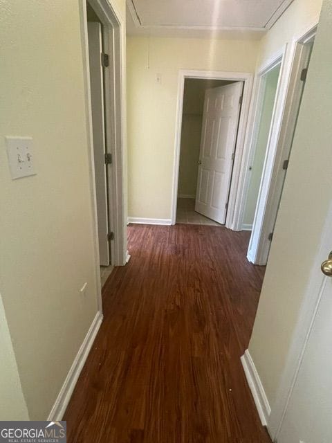 hallway with dark wood-type flooring