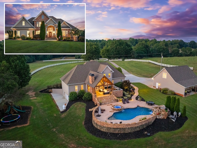 view of pool with a lawn and a patio