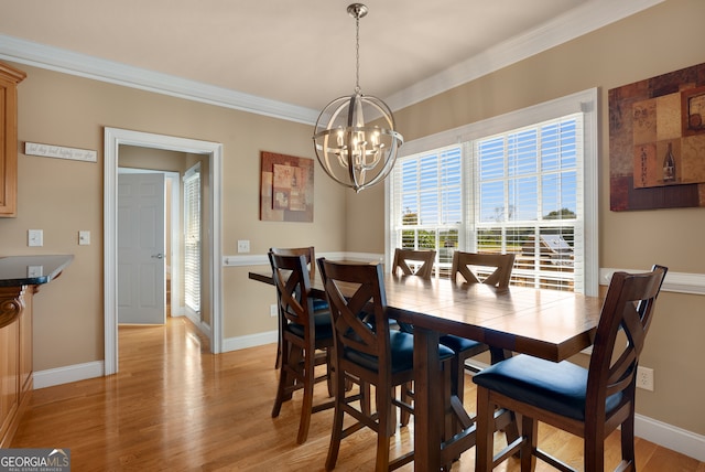 dining space featuring ornamental molding, a chandelier, and light hardwood / wood-style floors