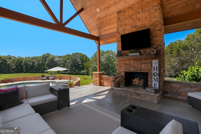 view of patio / terrace with an outdoor living space with a fireplace