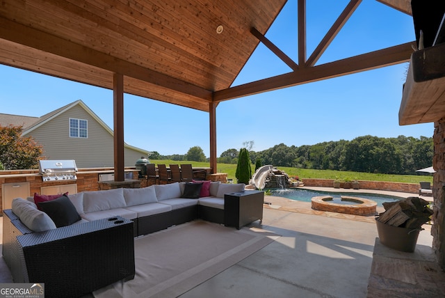 view of patio / terrace featuring a pool with hot tub, an outdoor kitchen, pool water feature, an outdoor living space, and grilling area