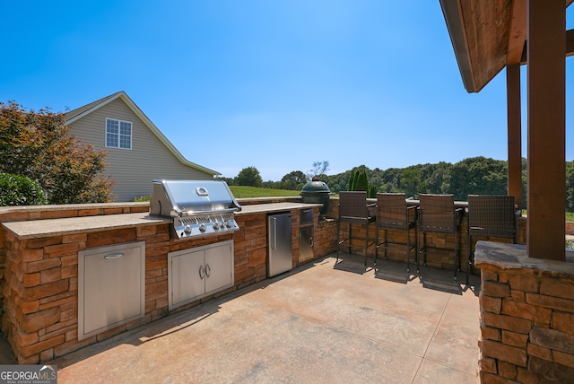 view of patio with area for grilling and an outdoor kitchen