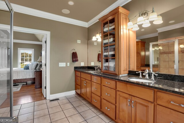 bathroom with vanity, ornamental molding, an enclosed shower, and hardwood / wood-style flooring