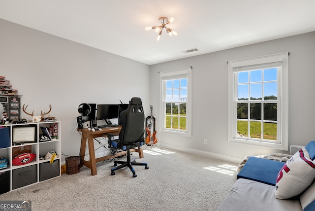 office space featuring an inviting chandelier and carpet flooring