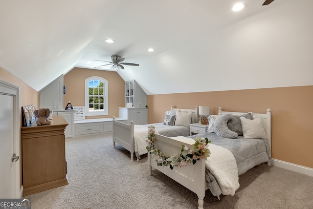 carpeted bedroom with ceiling fan and vaulted ceiling