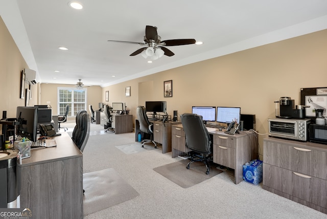 office space featuring ceiling fan and light colored carpet