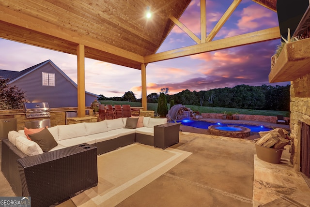 patio terrace at dusk featuring outdoor lounge area, pool water feature, area for grilling, and an in ground hot tub