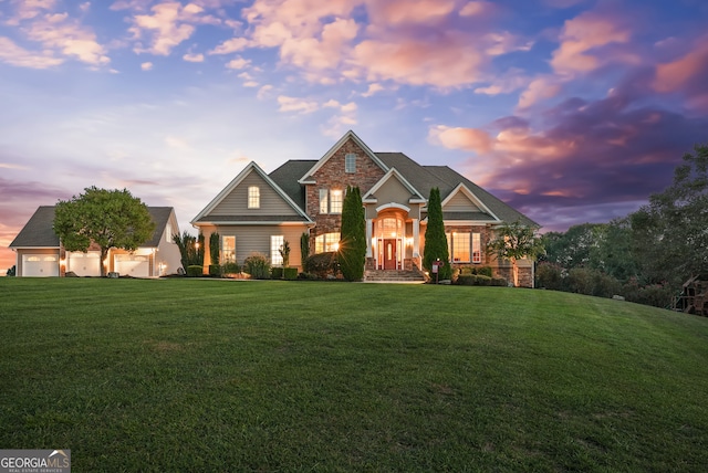 craftsman inspired home featuring a yard and a garage