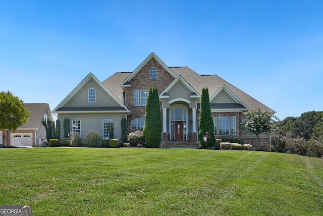 craftsman-style home featuring a garage and a front lawn