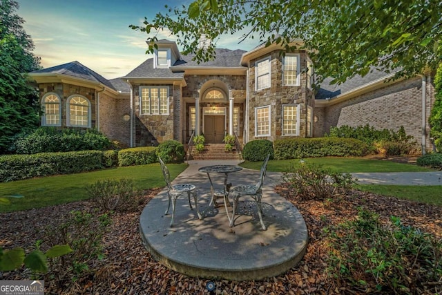 exterior space featuring a front lawn and stone siding