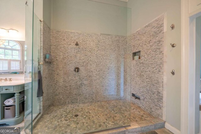 bathroom featuring vanity and a tile shower