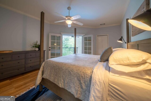 bedroom featuring wood-type flooring, ceiling fan, crown molding, and french doors