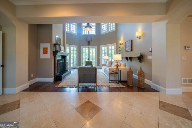 unfurnished living room featuring crown molding and hardwood / wood-style flooring