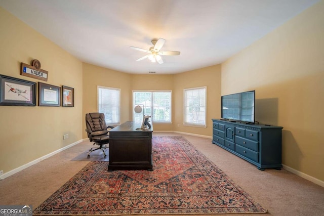 carpeted home office with ceiling fan