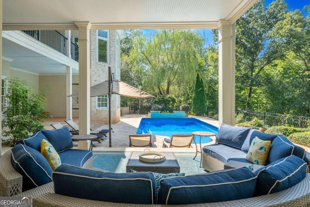 view of patio with a balcony, a fenced in pool, and an outdoor hangout area