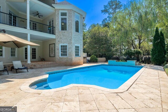 view of pool with a patio area and ceiling fan