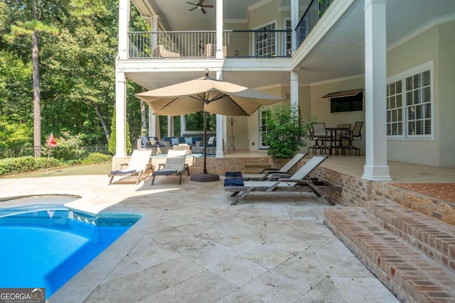 view of patio featuring a balcony, ceiling fan, and an outdoor hangout area