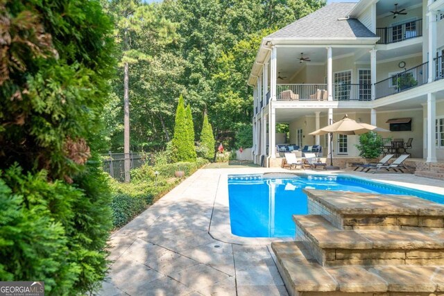 view of pool featuring ceiling fan and a patio area