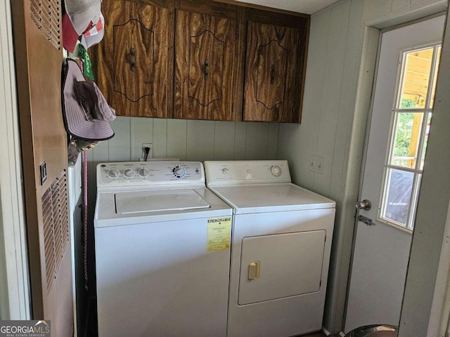 laundry area with cabinets and washing machine and dryer