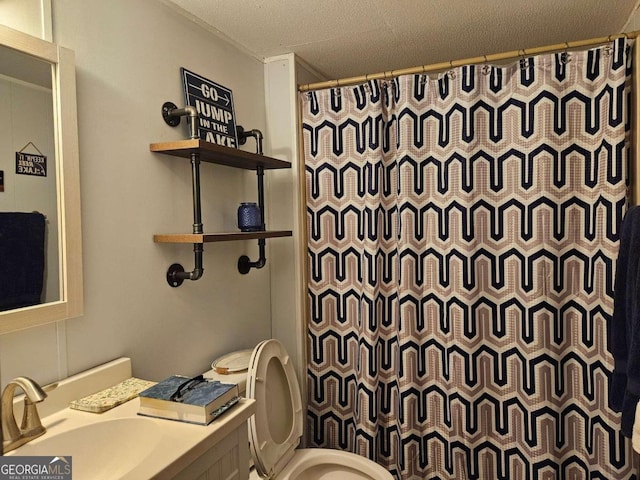 bathroom featuring a textured ceiling, vanity, toilet, and a shower with shower curtain