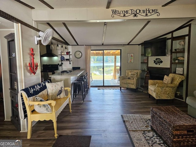 living room featuring lofted ceiling with beams, a textured ceiling, and dark hardwood / wood-style floors