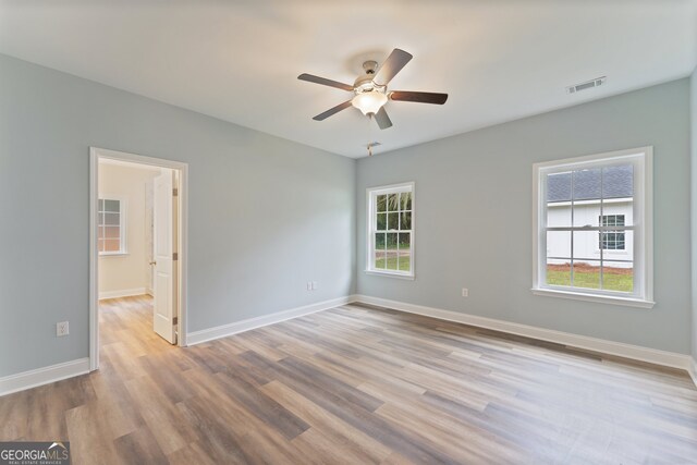 spare room with light hardwood / wood-style flooring and ceiling fan