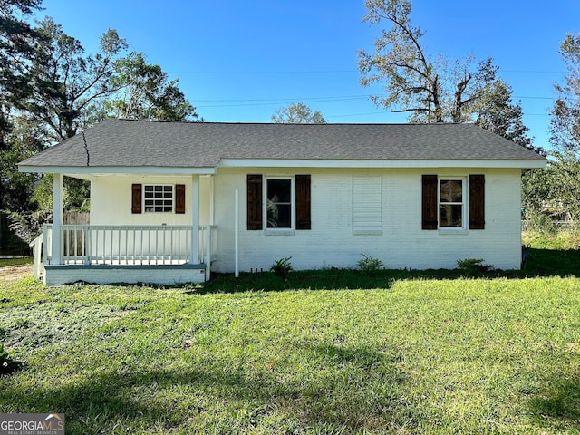 ranch-style home featuring a porch and a front yard