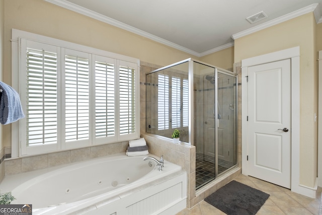 bathroom featuring plus walk in shower, tile patterned floors, and a healthy amount of sunlight