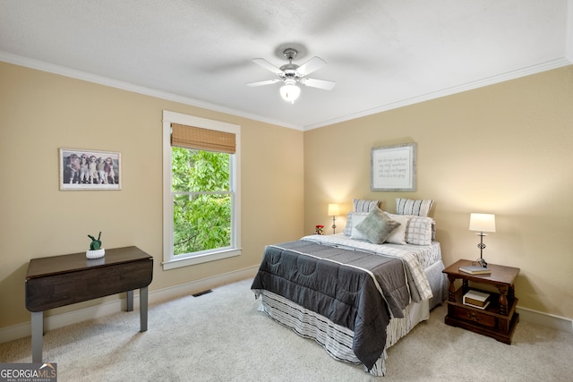 bedroom with ornamental molding, ceiling fan, and light colored carpet