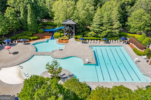 view of swimming pool with a gazebo, a water slide, and a patio area