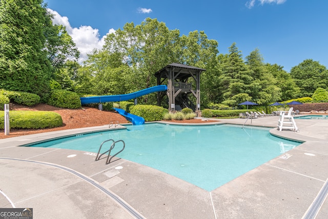 view of swimming pool featuring a patio and a water slide