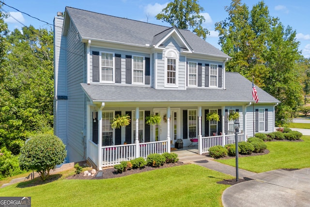 view of front of property with a front yard and a porch