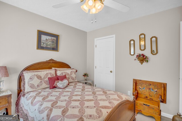 bedroom with a textured ceiling and ceiling fan