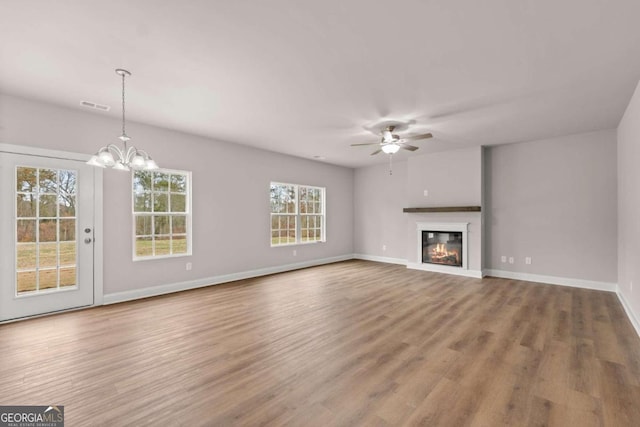 32 Joseph Ln, Hartwell, GA 30643 - unfurnished living room featuring ceiling fan, wood finished floors, a chandelier, and a glass covered fireplace